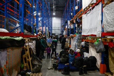 Migrants gather at the transport and logistics centre Bruzgi on the Belarusian-Polish border, in the Grodno region, Belarus December 22, 2021. (Reuters)