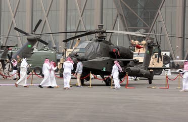 People look at a military helicopter at World Defense Show, amid Russia's invasion of Ukraine, in Riyadh, Saudi Arabia, March 7, 2022. (Reuters)