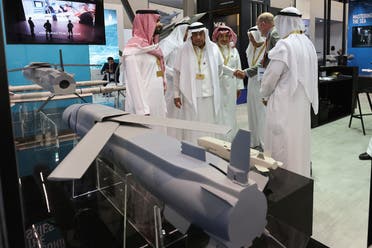 Men talk at World Defense Show, in Riyadh, Saudi Arabia, March 7, 2022. (Reuters)