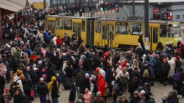 Refugees fleeing the ongoing Russian invasion of Ukraine wait for hours to board a train to Poland, outside the train station in Lviv, Ukraine, March 8, 2022. (Reuters)