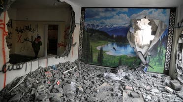 A child stands in the house of a Palestinian man accused of killing an Israeli after it was blown up and partially demolished by Israeli forces, near Jenin in the Israeli-occupied West Bank, March 8, 2022. (Reuters)