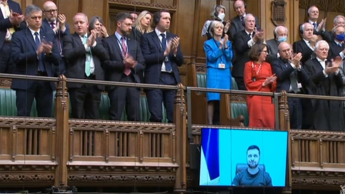 A video grab from footage broadcast by the UK Parliament's Parliamentary Recording Unit (PRU) shows MPs giving a standing ovation to Ukraine's President Volodymyr Zelensky after he speaks to them by live video-link in the House of Commons, in London, on March 8, 2022. (AFP)