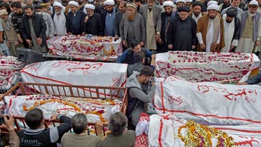 Mourners offer funeral prayers for bomb blast victims a day after a suicide attack at a Shiite mosque in Peshawar on March 5, 2022. (AFP)