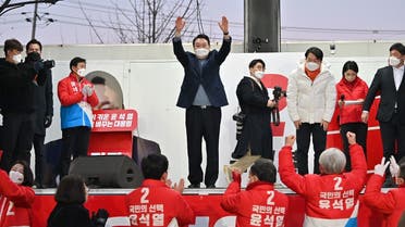 South Korea's presidential candidate Yoon Suk-yeol (C) of the main opposition People Power Party gestures to his supporters during an election campaign in Seoul on March 5, 2022, ahead of the March 9 presidential election. (AFP)