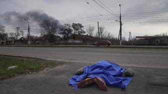 Besieged Ukraine city of Mariupol buries dead in mass grave