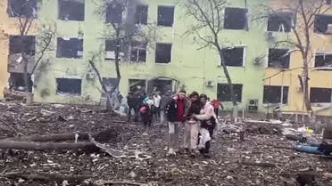 In this video grab from a handout footage taken and released by the the National Police of Ukraine on March 9, 2022, people are helped out of a damaged building of a children's hospital following a Russian air strike in the southeastern city of Mariupol. (AFP)