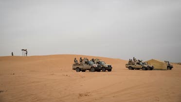 Mauritanian soldiers stand guard in a vehicle at a G5 Sahel task force command post, on November 22, 2018, in the southeast of Mauritania near the border with Mali. Remote villages near the border with Mali, have long been neglected by authorities, making them easier prey for jihadists and other armed groups that have proliferated in Africa's Sahel region. Now they are at the heart of a push to win over grassroots support in Mauritania with authorities ramping up both security operations and infrastructure development to stop the spread of extremism. / AFP / THOMAS SAMSON