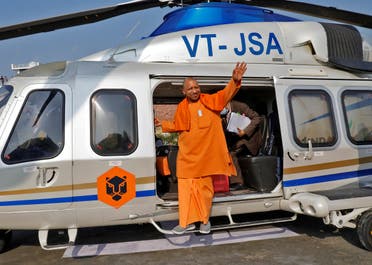 Yogi Adityanath, Chief Minister of the northern state of Uttar Pradesh, waves to his party supporters as he disembarks from a helicopter to attend an election campaign rally in Sambhal district of the northern state, India, on February 10, 2022. (Reuters)