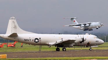 A People's Republic of China cargo plane flies near a US Navy P-3 Orion surveillance aircraft after unloading China military assistance to the Philippines at Clark Air Base, near Angeles City, Philippines June 28, 2017. (Reuters)