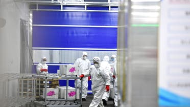 Staff members in protective suits transport goods at a newly built warehouse to storage and disinfect imported cold-chain products as a prevention method to curb the spread of the coronavirus disease (COVID-19), in Changchun, Jilin province, China January 25, 2021. (File photo: Reuters)