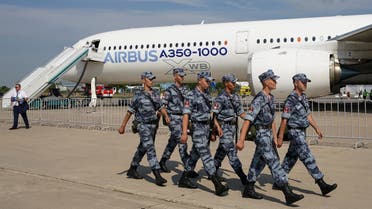Members of Russia’s National Guard walk past an Airbus A350-1000 airliner during an opening of the MAKS 2021 air show in Zhukovsky, outside Moscow, Russia, on July 20, 2021. (Reuters)