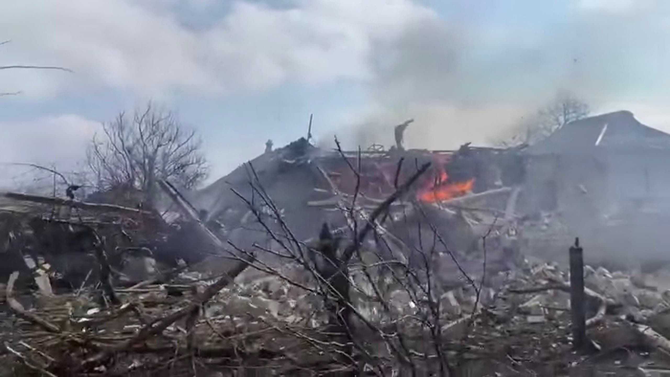 The aftermath of Russian artillery shelling on a residential area in Mariupol where a rocket hit a house, according to the Armed Forces of Ukraine, during the Russian invasion of Ukraine, in Mariupol, Ukraine, is seen in this screengrab from a video uploaded on social media on March 10, 2022. (Reuters)