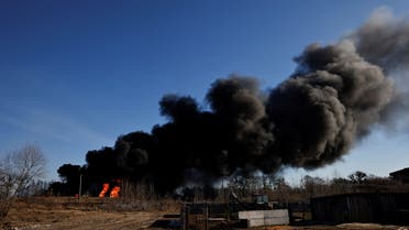A column of smoke rises from burning fuel tanks that locals said were hit by five rockets at the Vasylkiv Air Base, following Russia's invasion of Ukraine, outside Kyiv, Ukraine, March 12, 2022. (Reuters)