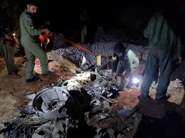 People work around what Pakistani security sources say is the remains of a missile fired into Pakistan from India, near Mian Channu, Pakistan, March 9, 2022. (Reuters)