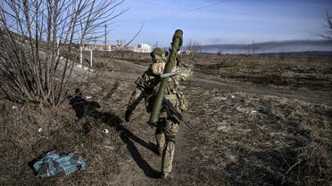 A Ukranian serviceman walks towards the front line in the city of Irpin, northern Ukraine, on March 12, 2022. Russian forces are positioned around Kiev on March 12, 2022 and are blocking Mariupol, where thousands of people are suffering a devastating siege, in southern Ukraine, a country that has been bombed for more than two weeks. (Photo by Aris Messinis / AFP)