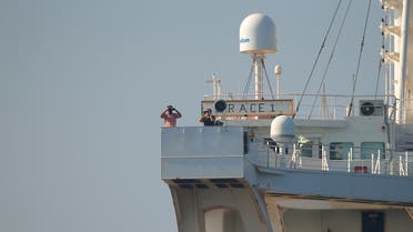 File photo shows crew members use binoculars aboard Iranian oil tanker Grace 1 as it sits anchored awaiting a court ruling on whether it can be freed after it was seized in July by British Royal Marines off the coast of the British Mediterranean territory, in the Strait of Gibraltar, southern Spain, August 15, 2019. (Reuters)