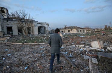 A man walks past damaged mansions following an overnight attack in Irbil, the capital of the northern Iraqi Kurdish autonomous region, on March 13, 2022. (AFP)
