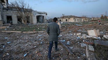 A man walks past damaged mansions following an overnight attack in Arbil, the capital of the northern Iraqi Kurdish autonomous region, on March 13, 2022. (AFP)
