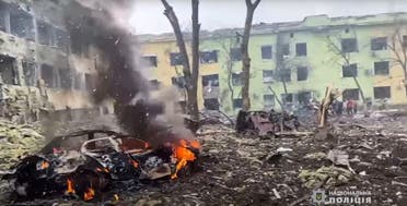 This video grab from a handout footage taken and released by the National Police of Ukraine on March 9, 2022, shows damaged buildings of a children’s hospital, destroyed cars and debris on ground following a Russian airstrike in the southeastern city of Mariupol. (AFP)