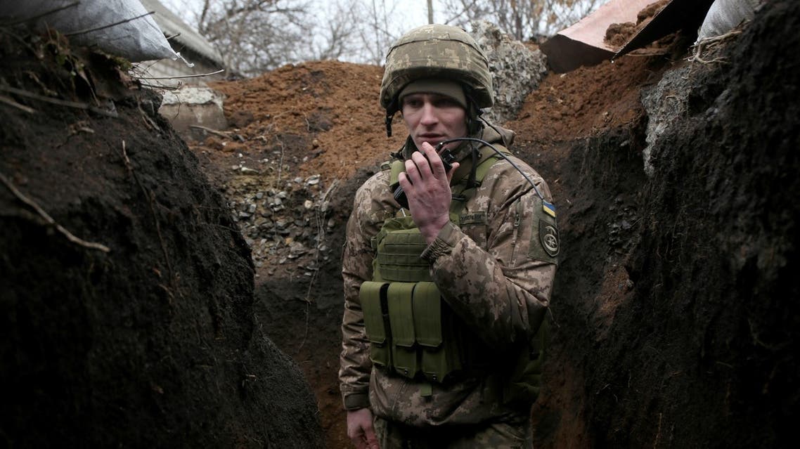 A serviceman of Ukrainian Military Forces speaks as he keeps position on the front line with Russia backed separatists, near Novolugansk, in the Donetsk region, on February 17, 2022. (AFP)