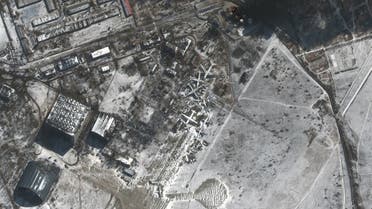 This Maxar satellite image taken and released on March 10, 2022 shows the southern end of Antonov Airport and fires at a fuel storage area (top R) in Hostomel, Ukraine. (AFP)