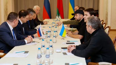 Members of delegations from Ukraine and Russia, including Russian presidential aide Vladimir Medinsky (2L), Ukrainian presidential aide Mykhailo Podolyak (2R), Volodymyr Zelensky's Servant of the People lawmaker Davyd Arakhamia (3R), hold talks in Belarus' Gomel region on February 28, 2022, following the Russian invasion of Ukraine. (AFP)