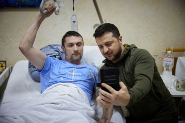 Ukraine's President Volodymyr Zelenskyy visits an injured Ukrainian serviceman at a military hospital, as Russia's attack on Ukraine continues, in Kyiv, Ukraine March 13, 2022. (Reuters)