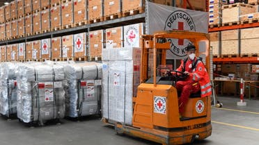 A German Red Cross (DRK) employee operates a forklift with humanitarian supplies to load for a first aid transport to Poland for those fleeing Russia's invasion in Ukraine, at the DRK logistics center in Schoenefeld near Berlin, Germany, March 1, 2022. REUTERS/Annegret Hilse