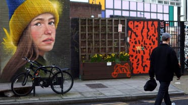 A man walks past a mural in support of Ukraine by artist WOSKerski, as Russia's invasion of Ukraine continues, in London, Britain, March 14, 2022. (Reuters)