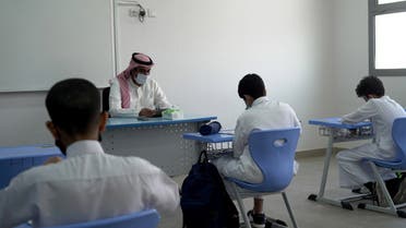 A Saudi teacher wearing a face mask teaches a class at a school in Riyadh, Saudi Arabia August 30, 2021. (Reuters)