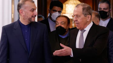 Russian Foreign Minister Sergei Lavrov (R) and Iranian Foreign Minister Hossein Amir-Abdollahian enter a hall during a meeting in Moscow on March 15, 2022. (AFP)