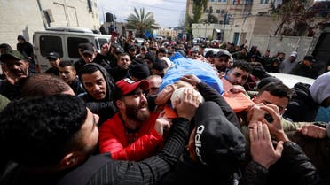 People carry the body of Palestinian Alaa Shaham, who was killed by Israeli forces during clashes, in Ramallah in the Israeli-occupied West Bank March 15, 2022. (Reuters)