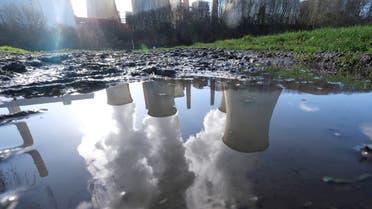 The lignite (brown coal) power plant complex of German energy supplier and utility RWE is reflected in a puddle in Neurath, north-west of Cologne, Germany, February 5, 2020. (Reuters)