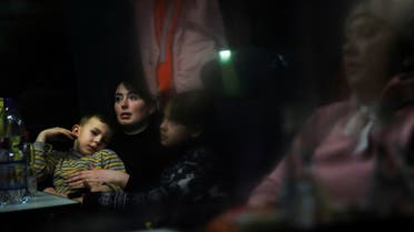 Ukrainian refugees travel on a train to Budapest after arriving from the border with Ukraine fleeing their country following the Russian invasion, at North Railway Station in Bucharest, Romania, March 14, 2022. REUTERS/Edgard Garrido