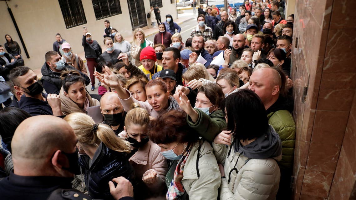 Ukrainian refugees queue to get one of the 100 daily appointments at the documentation office to apply for temporary protection approved by the European Union that allows residence and a work permit, in Torrevieja, Spain March 15, 2022. (Reuters)