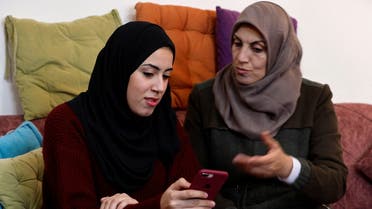 Palestinian university student Samar Aita, who studied in Ukraine, chats with her mother at her house, in Rafah in the southern Gaza Strip, March 13, 2022. (Reuters)