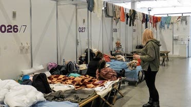 People seen in a part of temporary COVID-19 hospital that was turned into shelter for people fleeing Ukraine amid Russian invasion, in Poznan, Poland on March 11, 2022. (Reuters)