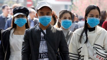 Tourists wear protective masks while visiting Hoan Kiem lake in Hanoi, Vietnam. (Reuters)