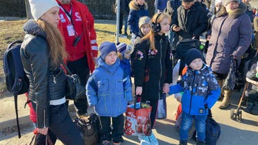 A Ukrainian Red Cross worker waits with residents as they board  busses to leave the city as part of a safe passage out of Sumy,  Ukraine. (Supplied)