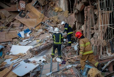 Ukrainian firefighters work by a destroyed apartment building in Kharkiv, Ukraine, on March 16, 2022. (AP)