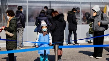 People wait in line to undergo the coronavirus disease (COVID-19) test at a temporary testing site set up in Seoul, South Korea, February 16, 2022. REUTERS/ Heo Ran