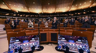 Members of the political delegations of the Parliamentary Assembly of the the Council of Europe applaud after a minute of silence for the victims of the Russian invasion of Ukraine on March 14, 2022 at the Council of Europe in Strasbourg, northeastern France. (AFP)