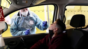 A boy is tested for the coronavirus disease (COVID-19) at a drive-through site as Israel faces a surge in Omicron variant infections, in Jerusalem, January 10, 2022. REUTERS/Ronen Zvulun