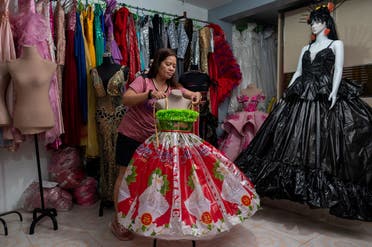 Nora Buenviaje displays a dress made of used sacks of rice and plastic bags, at her shop in Cainta, Rizal Province, Philippines, March 3, 2022. (Reuters)