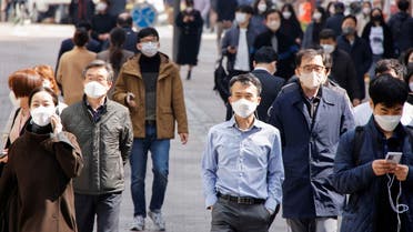 People wearing masks walk in a shopping district amid the coronavirus disease (COVID-19) pandemic in Seoul, South Korea, March 16, 2022. (Reuters)