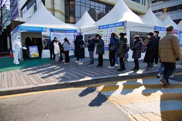 People wait in line to undergo the coronavirus disease (COVID-19) test at a testing site which is temporarily set up at a public health center in Seoul, South Korea, February 24, 2022. (Reuters)