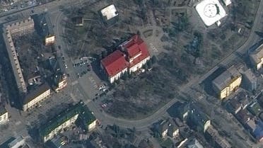 A satellite image shows a closer view of Mariupol Drama Theatre before bombing, as a word children in Russian is written in large white letters on the pavement in front of and behind the building, in Mariupol, Ukraine, March 14, 2022. (Reuters)