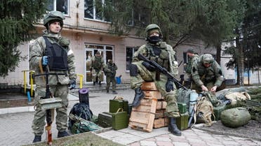 Servicemen of pro-Russian militia are seen outside the territorial defence headquarters in Stanytsia Luhanska in the Luhansk region, Ukraine February 27, 2022. (Reuters)