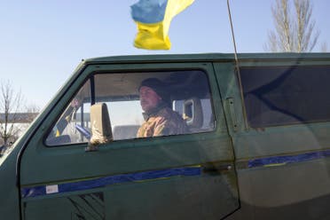A Ukrainian soldier drives a van which carries bodies of dead soldiers next to the military school hit by Russian rockets the day before, in Mykolaiv, southern Ukraine, on March 19, 2022. (AFP)