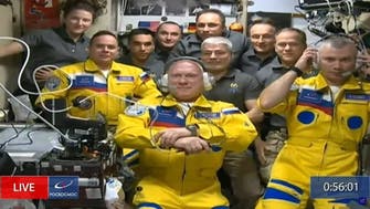Russia cosmonauts arrive at space station wearing Ukraine flag colors